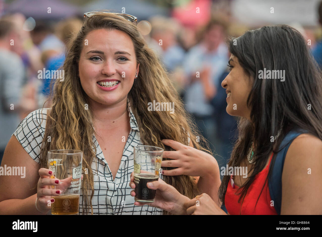 London, UK. 9th August, 2016. Women enjoying pints - The Great British Beer Festival organised by the Campaign for Real Ale (CAMRA) offers visitors over 900 real ales, ciders, perries and international beers at Olympia. Credit:  Guy Bell/Alamy Live News Stock Photo