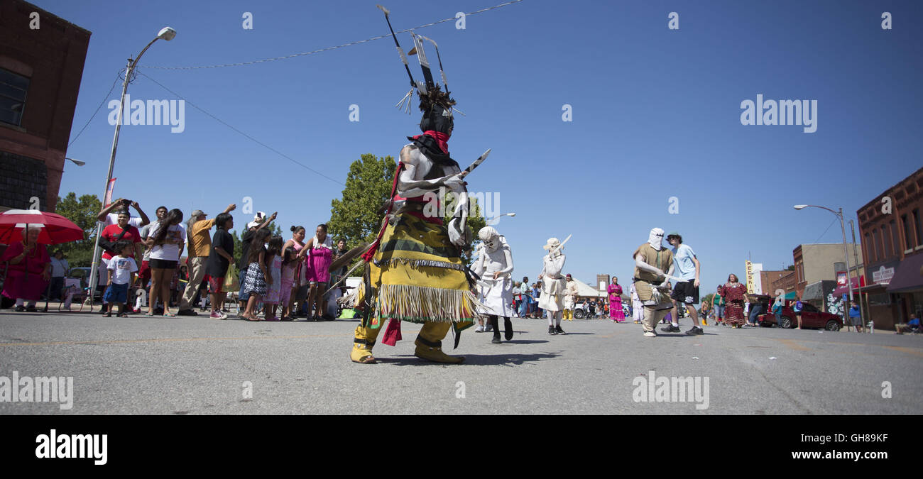 Anadarko, Oklahoma, USA. 8th Nov, 2016. A fire dancer marches during the annual American Indian Expo parade in Anadarko, Oklahoma.The annual American Indian Expo showcases the arts, crafts and traditions of 13 plains Indian tribes. The expo features The Chiricahua Apaches, commonly known as the Fort Sill Apache Fire Dancers. They perform the ''Dance of the Mountain Spirit'', which has been passed down to the Gooday family from generations of ancestors. The dance is said to drive away sickness and evil and bring good health and fortune. © J Pat Carter/ZUMA Wire/Alamy Live News Stock Photo