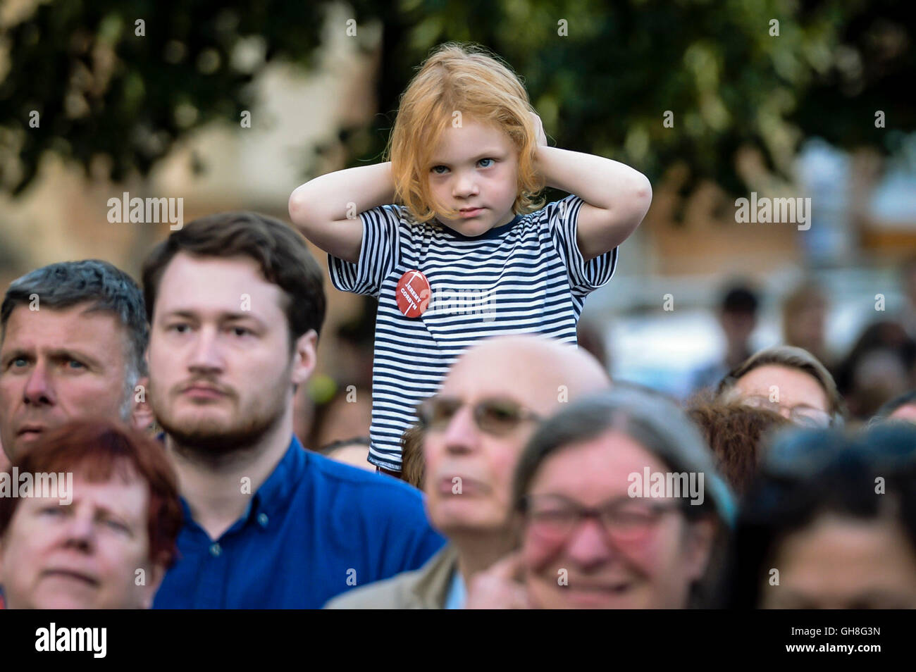 A youngster holds their ears as Labour leader Jeremy Corbyn takes part in a Labour leadership hustings at College Green, Bristol. Stock Photo