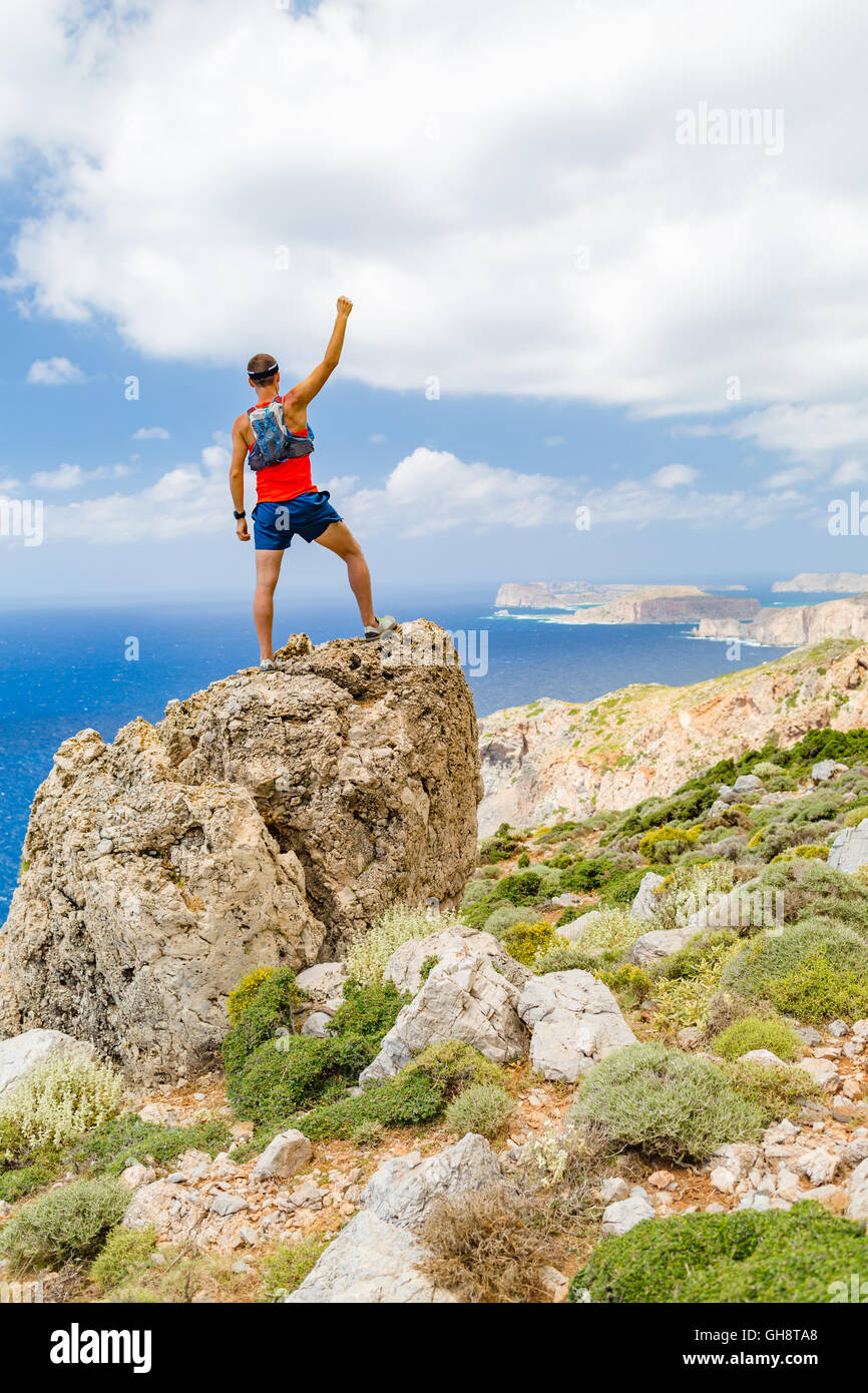 Success climbing and achievement, running or hiking Man celebrating with arms up