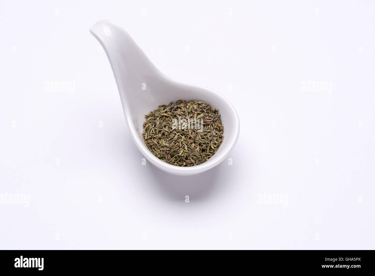 Monotone dry Thyme 1 tablespoon in a white spoon on the white background Stock Photo