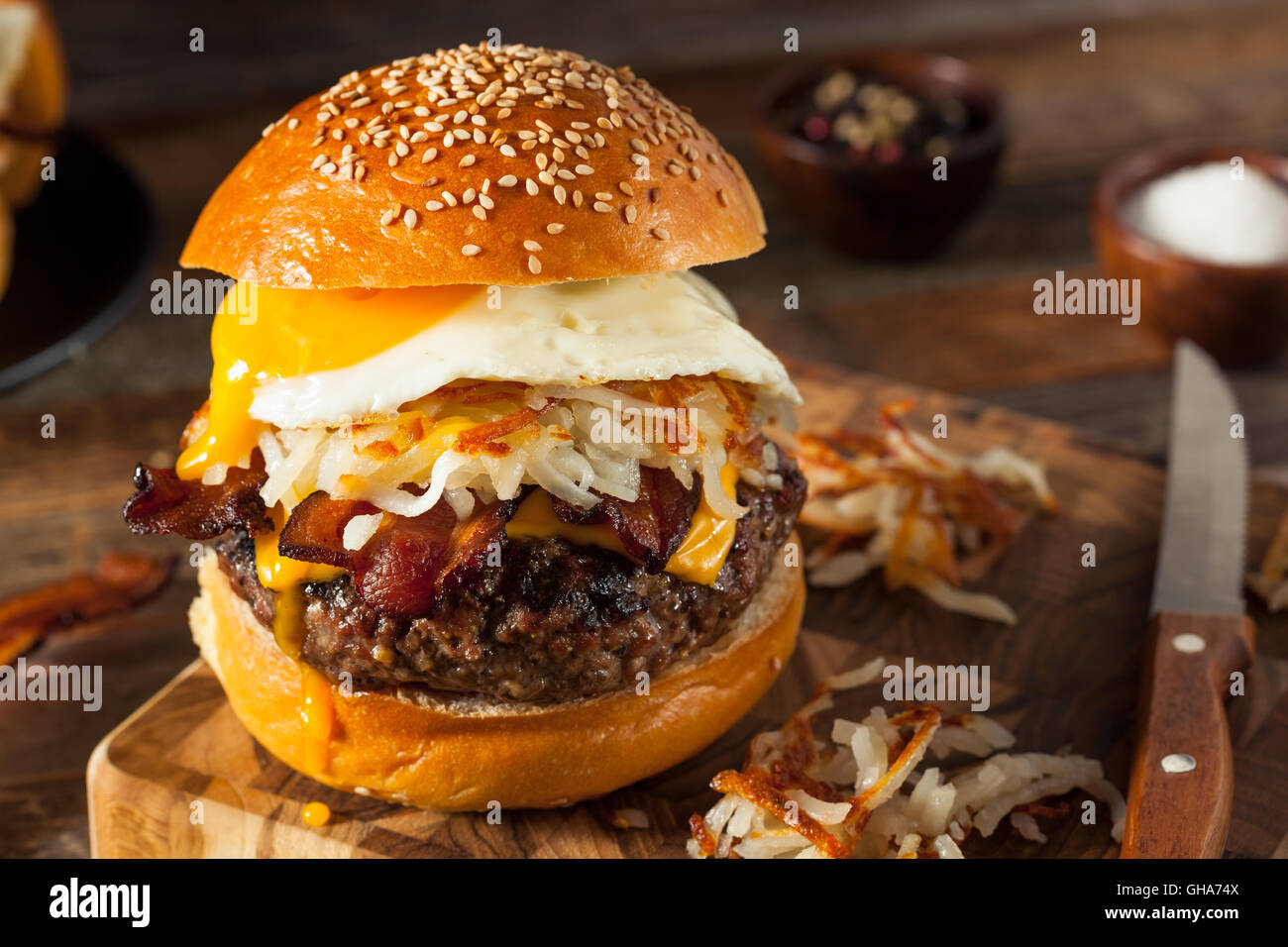 Homemade Breakfast Cheeseburger with Bacon Eggs and Hashbrowns Stock Photo