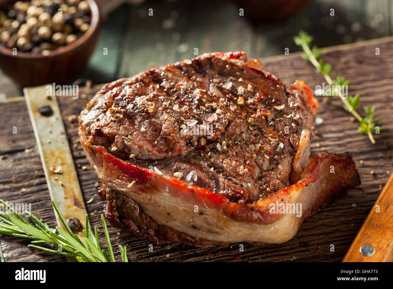 Organic Grass Fed Bacon Wrapped Sirloin Steak with Herbs Stock Photo