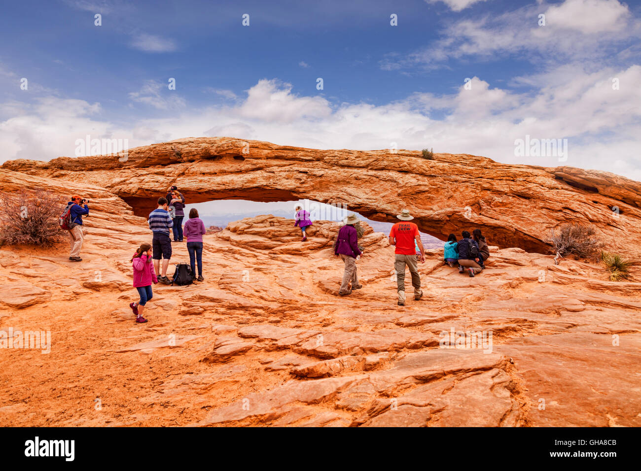 Tourists at Mesa Arch, a pothole arch in the Island in the Sky area of Canyonlands National Park, Utah, USA Stock Photo