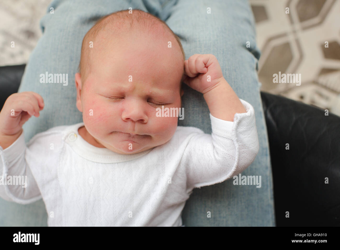 Cute newborn baby lying on mother lap Stock Photo