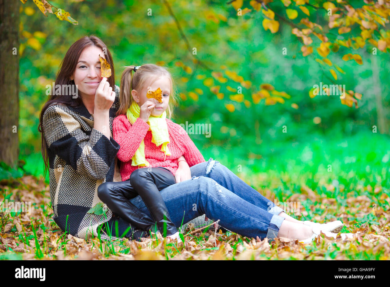 Adorable little girl with mother in autumn park outdoors Stock Photo ...