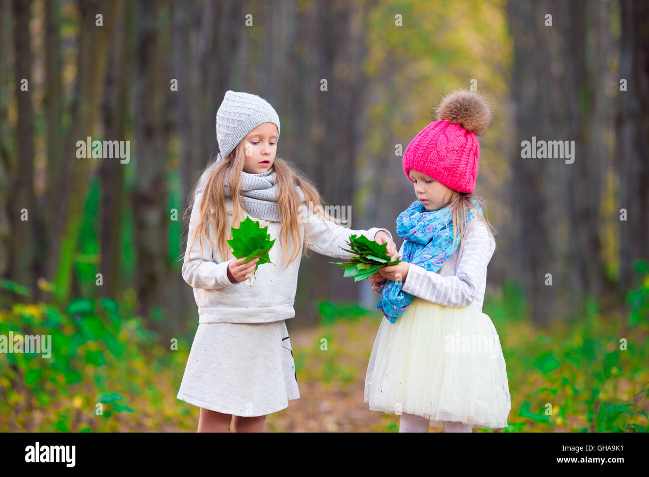 Little adorable girls outdoors at warm sunny autumn day Stock Photo - Alamy