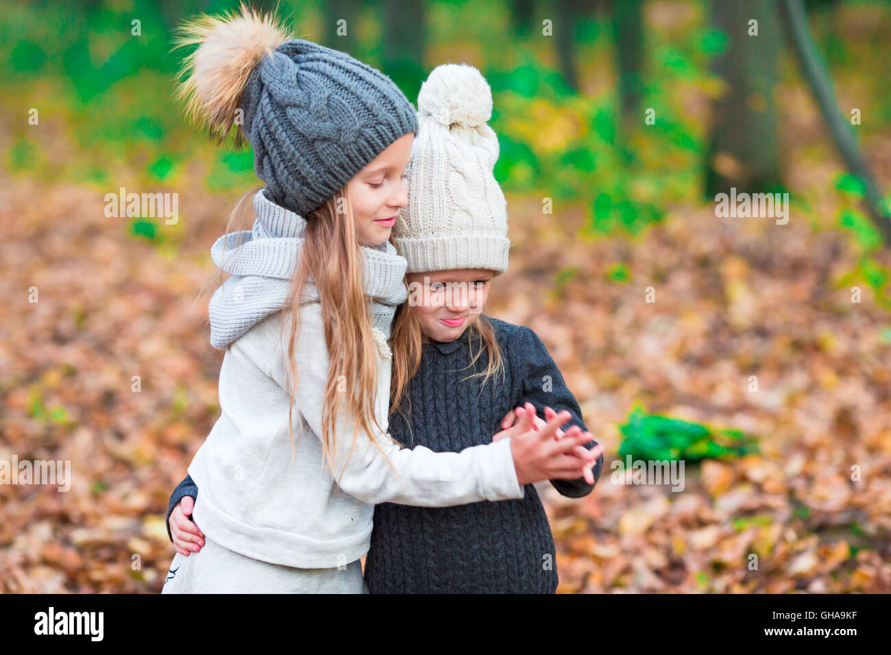 Little adorable girls outdoors at warm sunny autumn day Stock Photo - Alamy