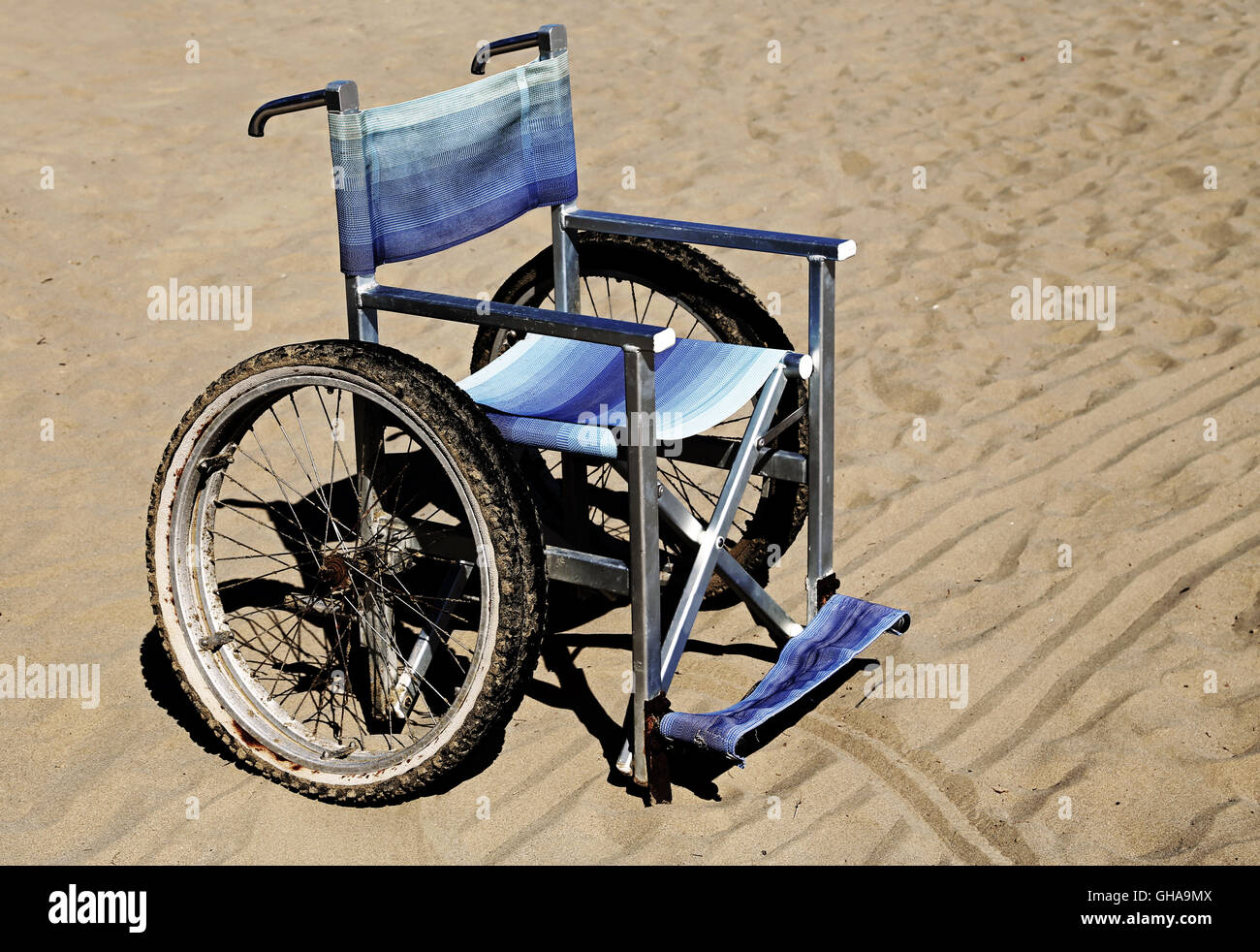 wheelchair on the sand of the beach in summer Stock Photo Alamy