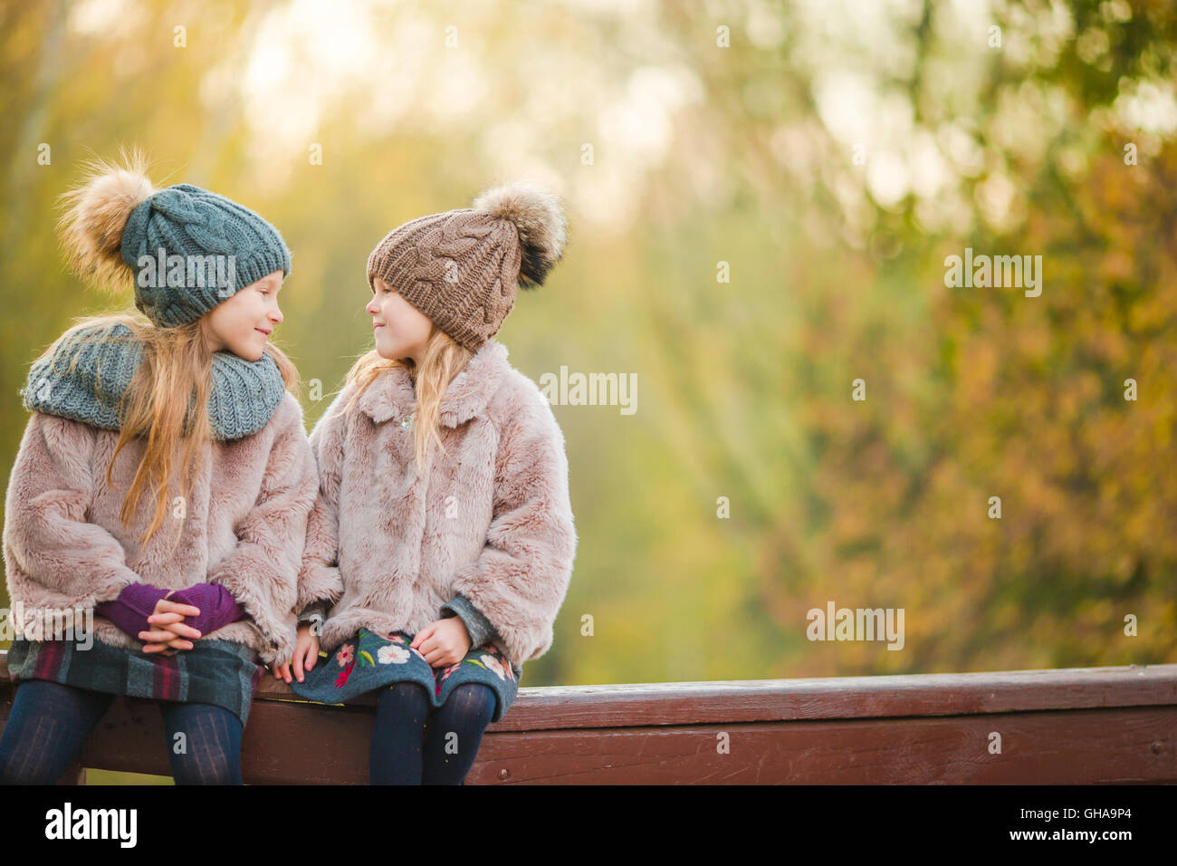 Little adorable girls at warm sunny autumn day outdoors Stock Photo - Alamy