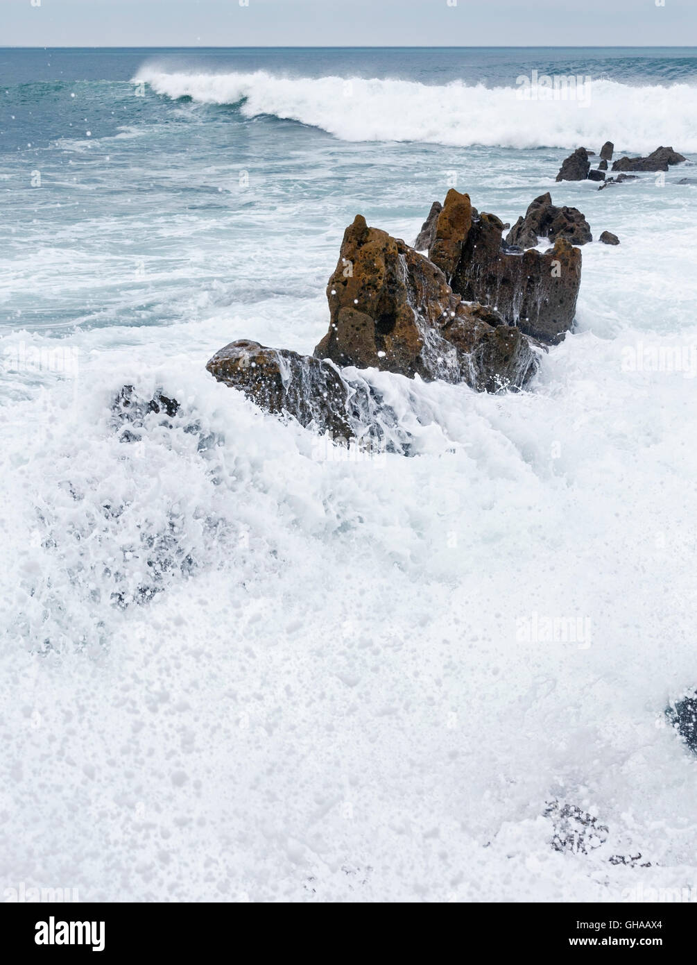 Ocean surf wave and big boulders in foam, Biscay, Spain Stock Photo Alamy