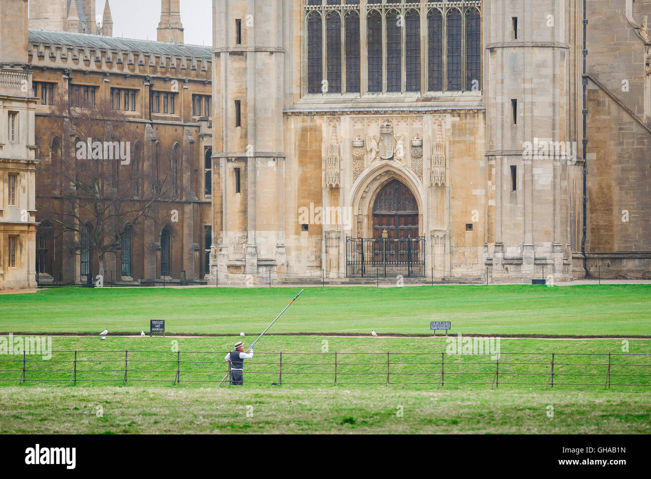 On the River Cam a man pilots his punt past the west front of King's College Chapel, Cambridge, UK. Stock Photo
