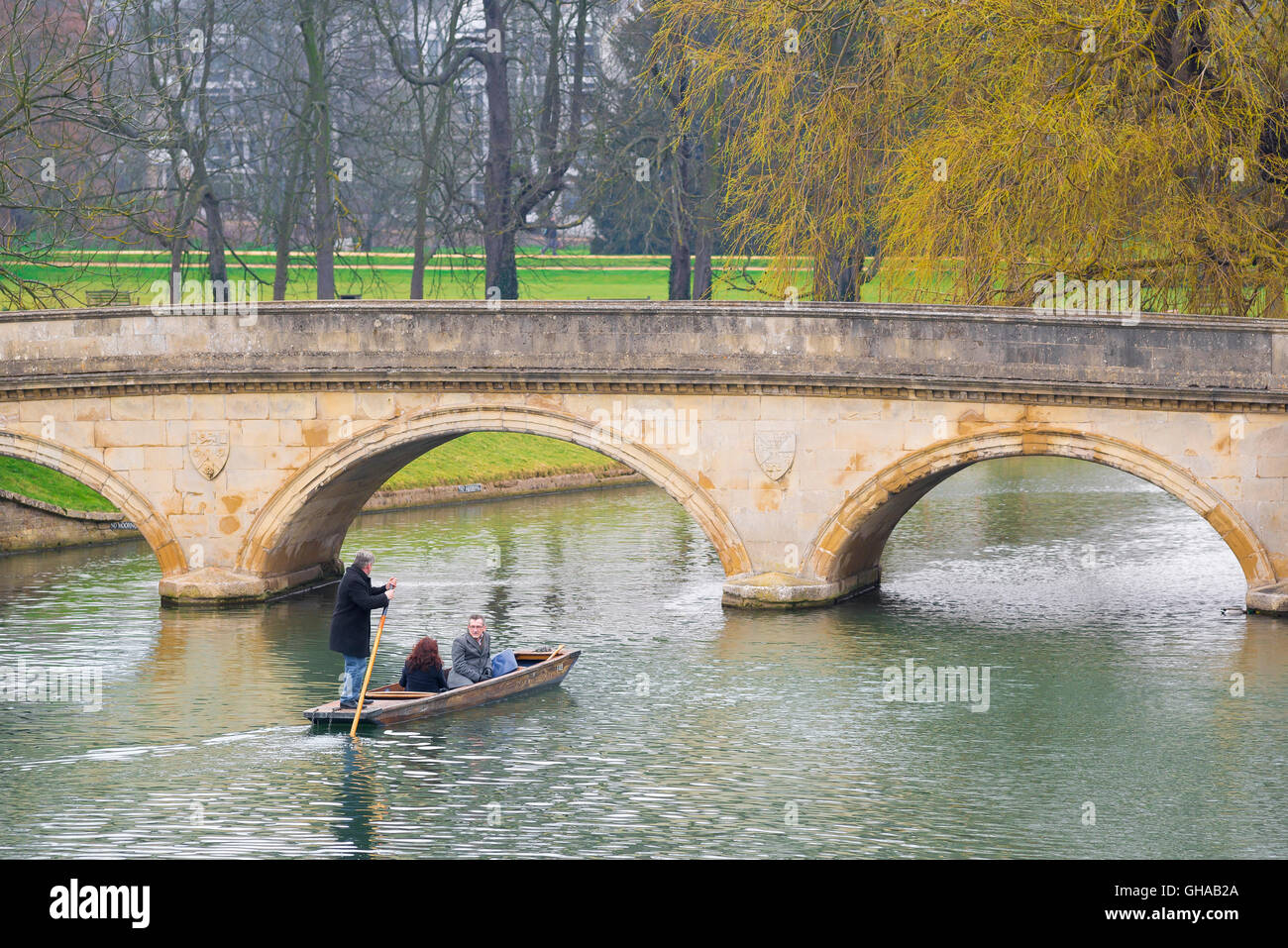On an early spring morning in Cambridge, UK, tourists take a trip in a punt on the River Cam. Stock Photo
