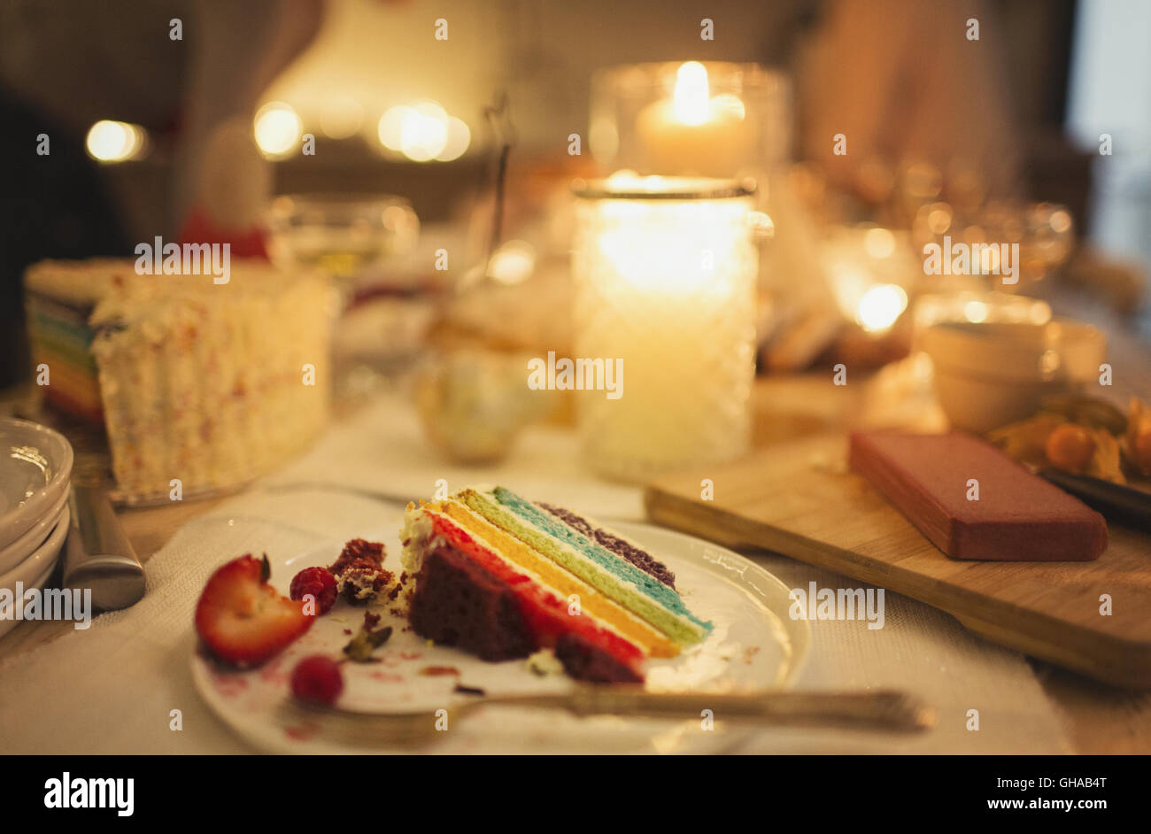 Leftover cake on candlelight table Stock Photo