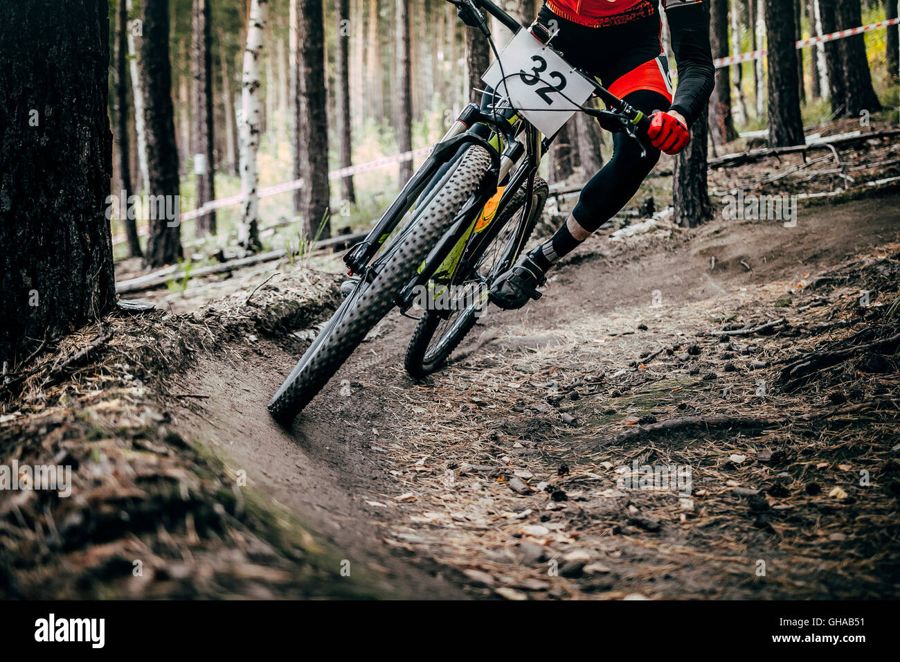 cyclist mountainbiker rides in forest. extreme sports cross-country Stock Photo