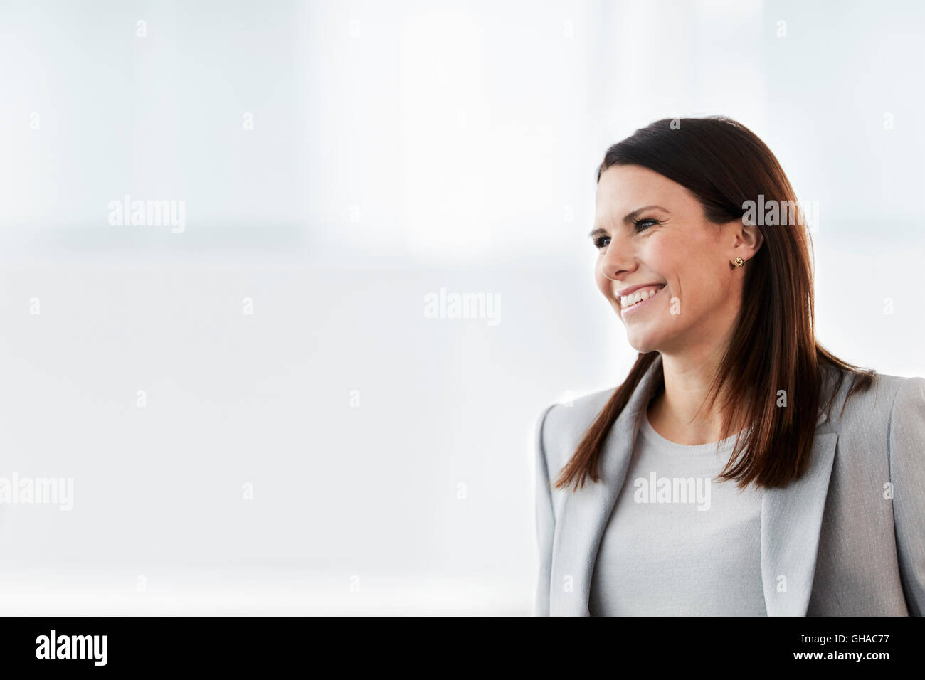 Smiling businesswoman looking away Stock Photo