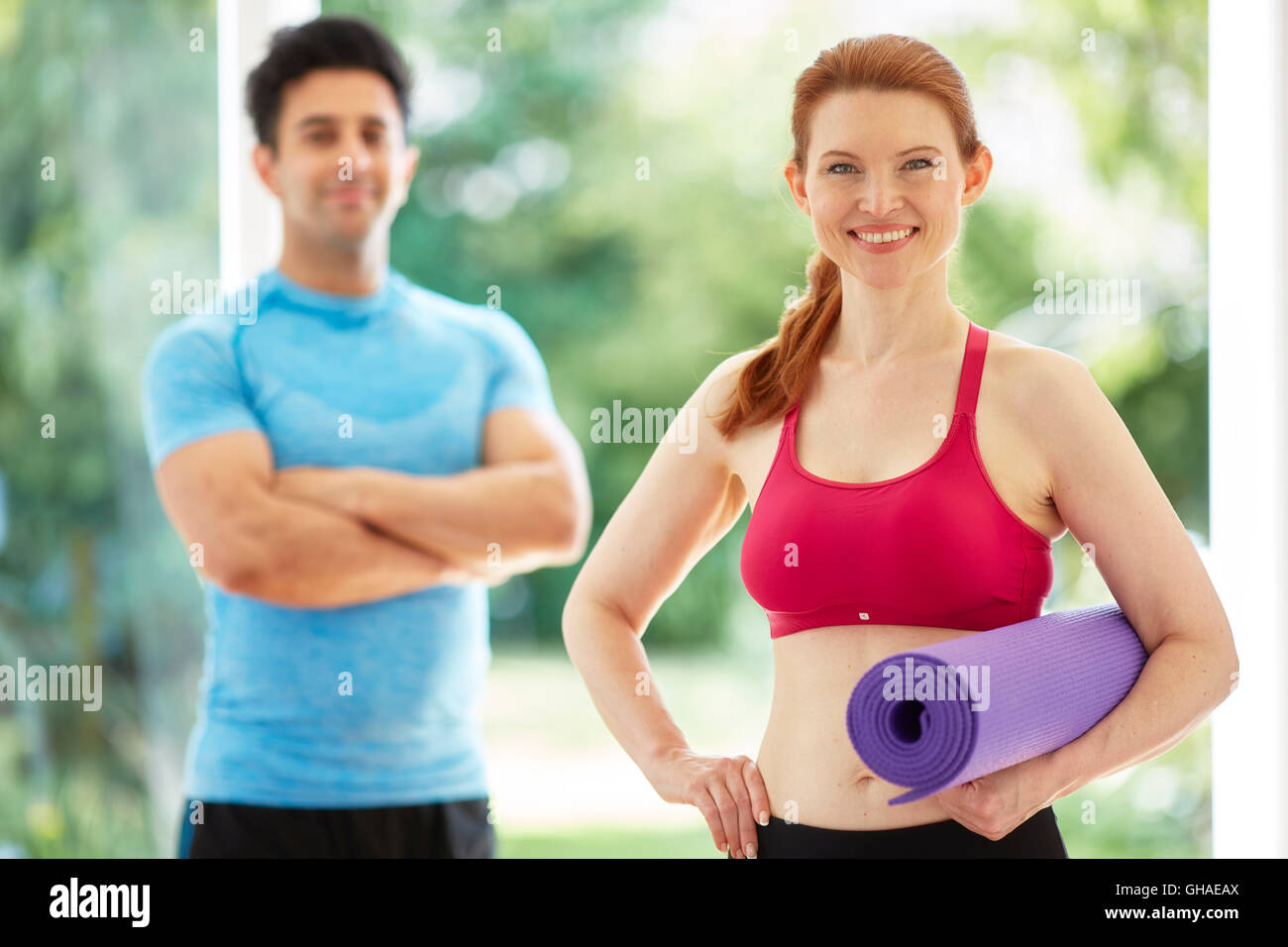 Couple stood together in gym Stock Photo