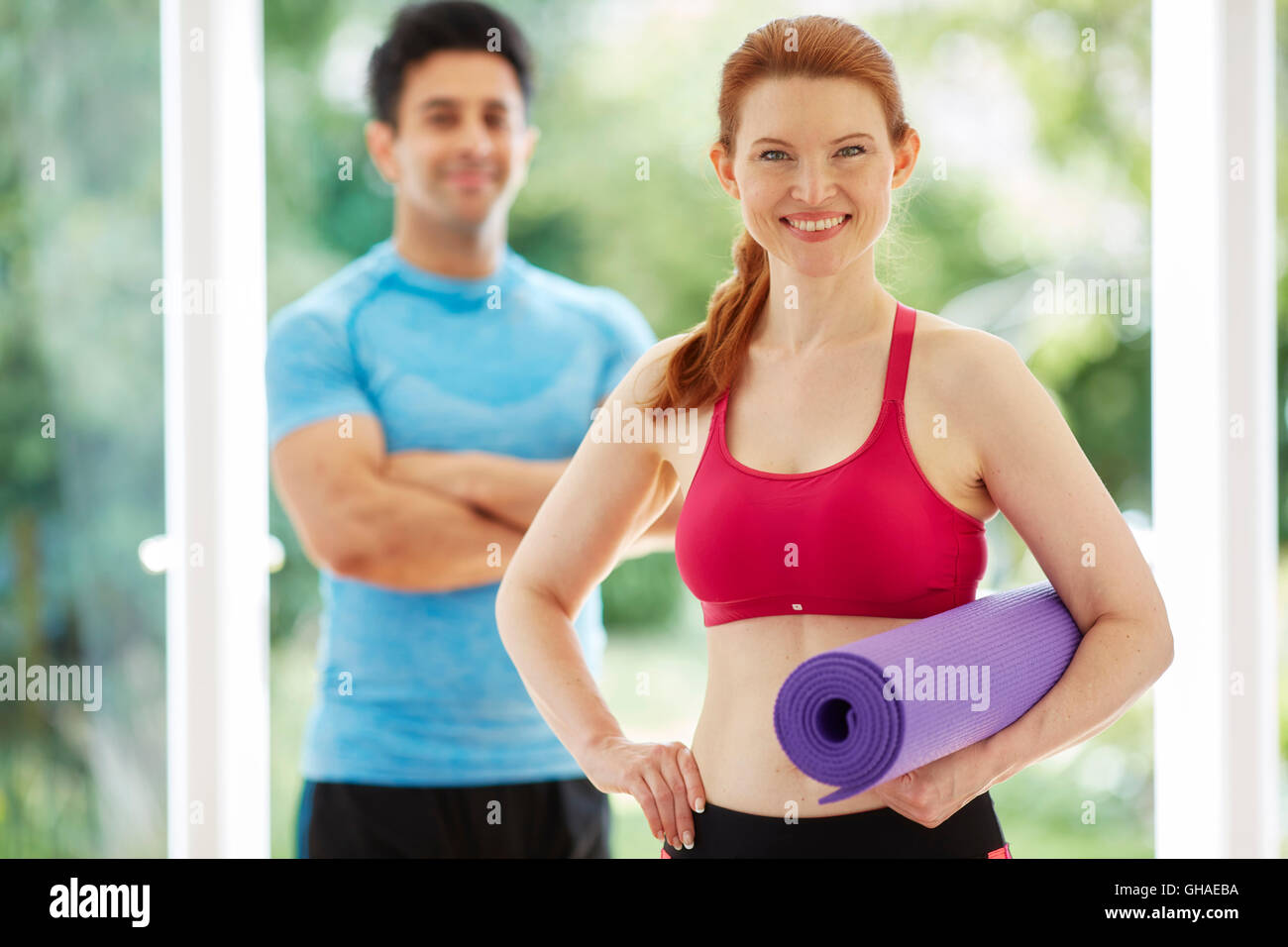 Couple stood together in gym Stock Photo