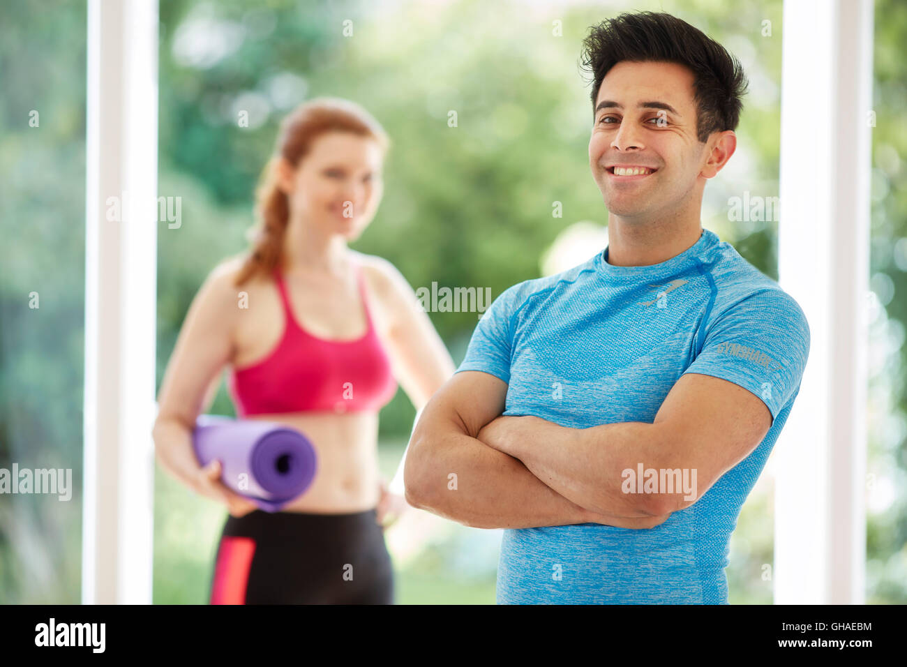 Couple stood together in gym Stock Photo