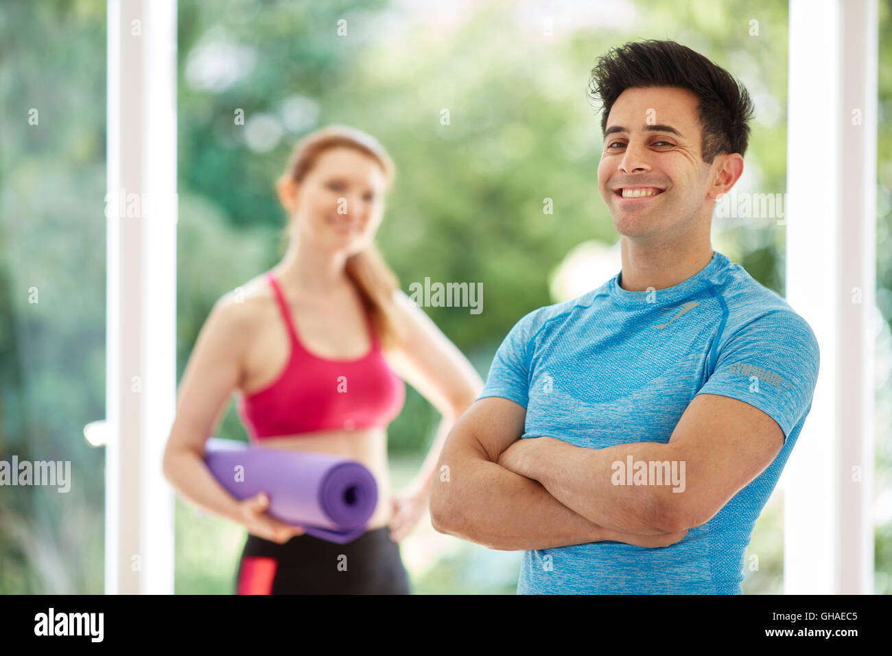 Couple stood together in gym Stock Photo