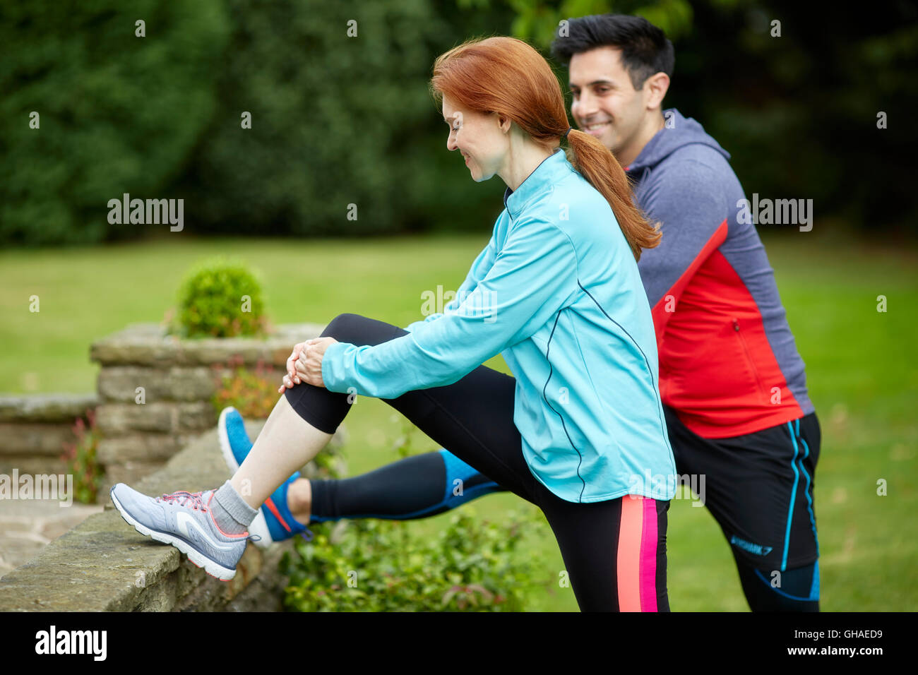 Couple stretching warming up together Stock Photo