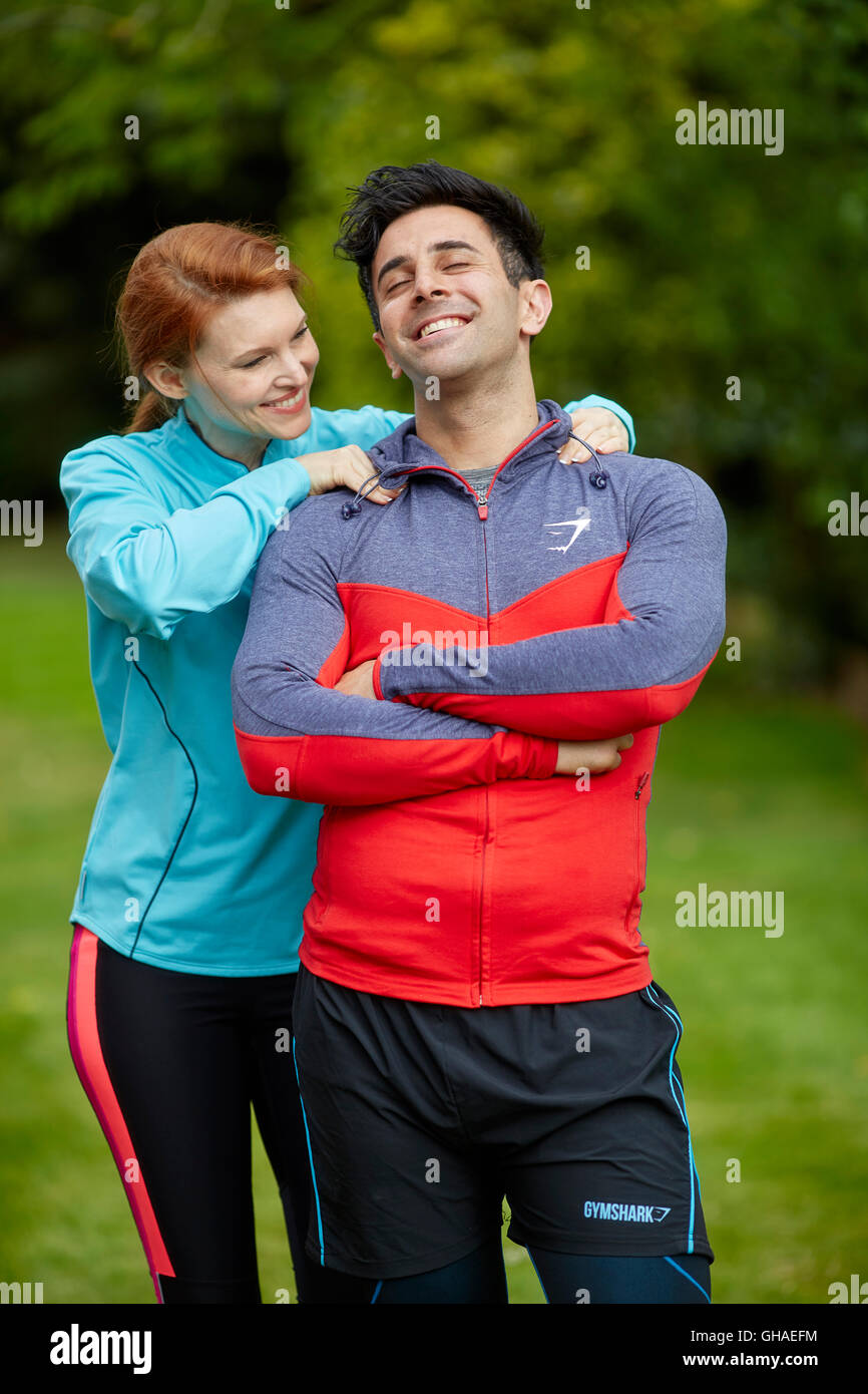 Couple exercising together outdoors Stock Photo - Alamy