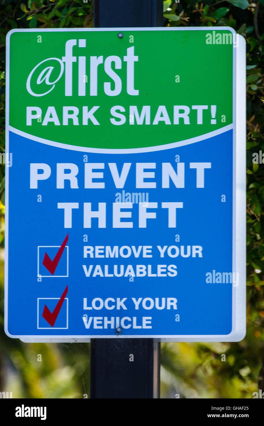 A sign in San Jose California reminding people to not leave valuable in their cars and to lock them Stock Photo