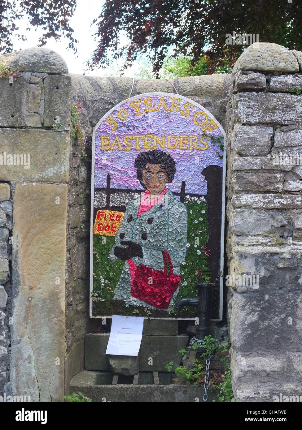 A well dressing depicting soap character Dot Cotton of Eastenders at Ashford-in-the-Water, Derbyshire. Stock Photo