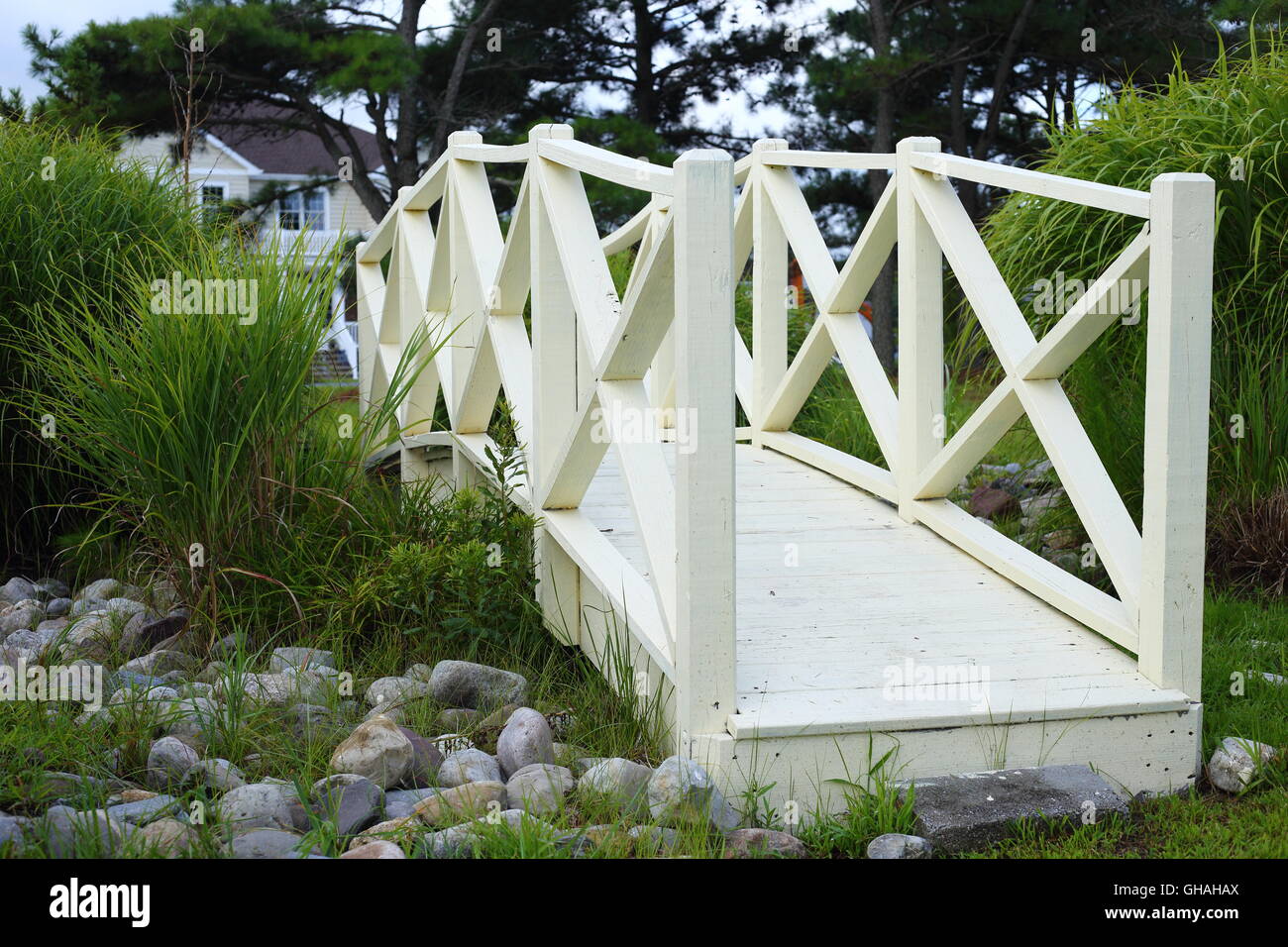 Yellow wooden footbridge in a green park Stock Photo