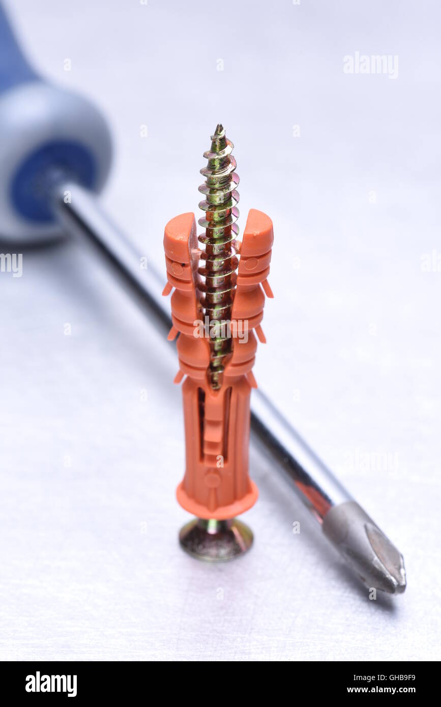 Screwdriver and dowel on metal background Stock Photo Alamy