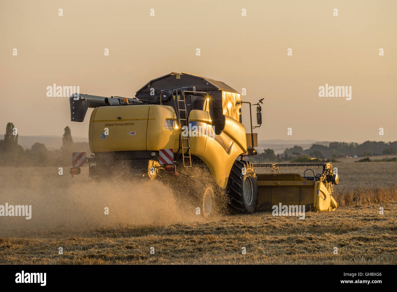 agriculture, combine during the harvest in the evening, administrative district Wolfenbuettel, Lower Saxony, Editorial-Use-Only Stock Photo