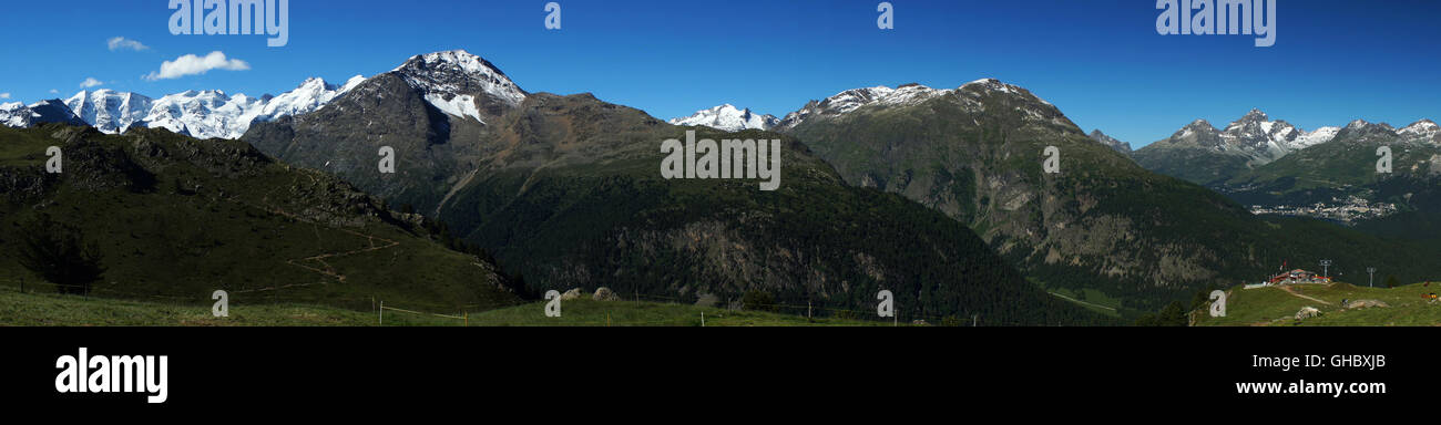 Panorama view of Engadine with (l) Sankt Moritz with mountain range from Piz Palü and Berninato Piz Nair seen from Alp Languard Stock Photo