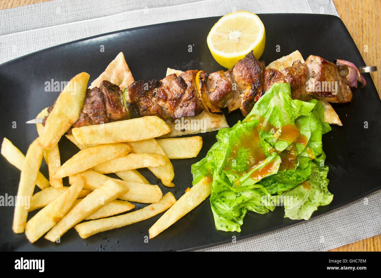 greek souvlaki with pita pork meat with potato fries Stock Photo Alamy