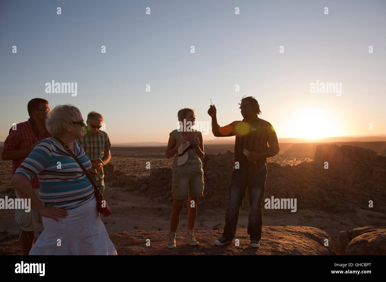 Visitors on Sundowners Hilltop at Canon Lodge in Namibia Stock Photo