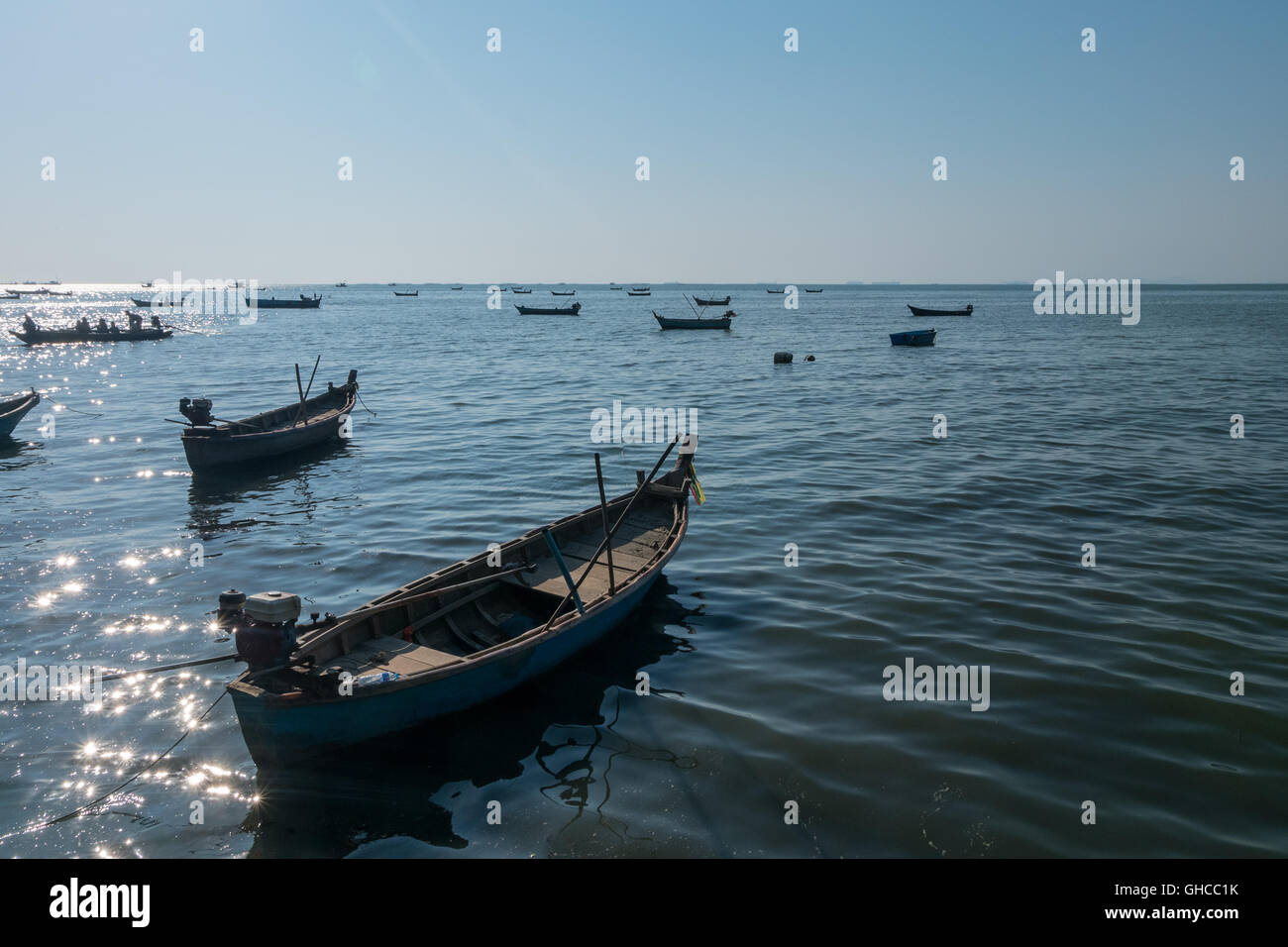beautiful view of fishing boats sailing in the sea in dusk sunset twilight time Stock Photo