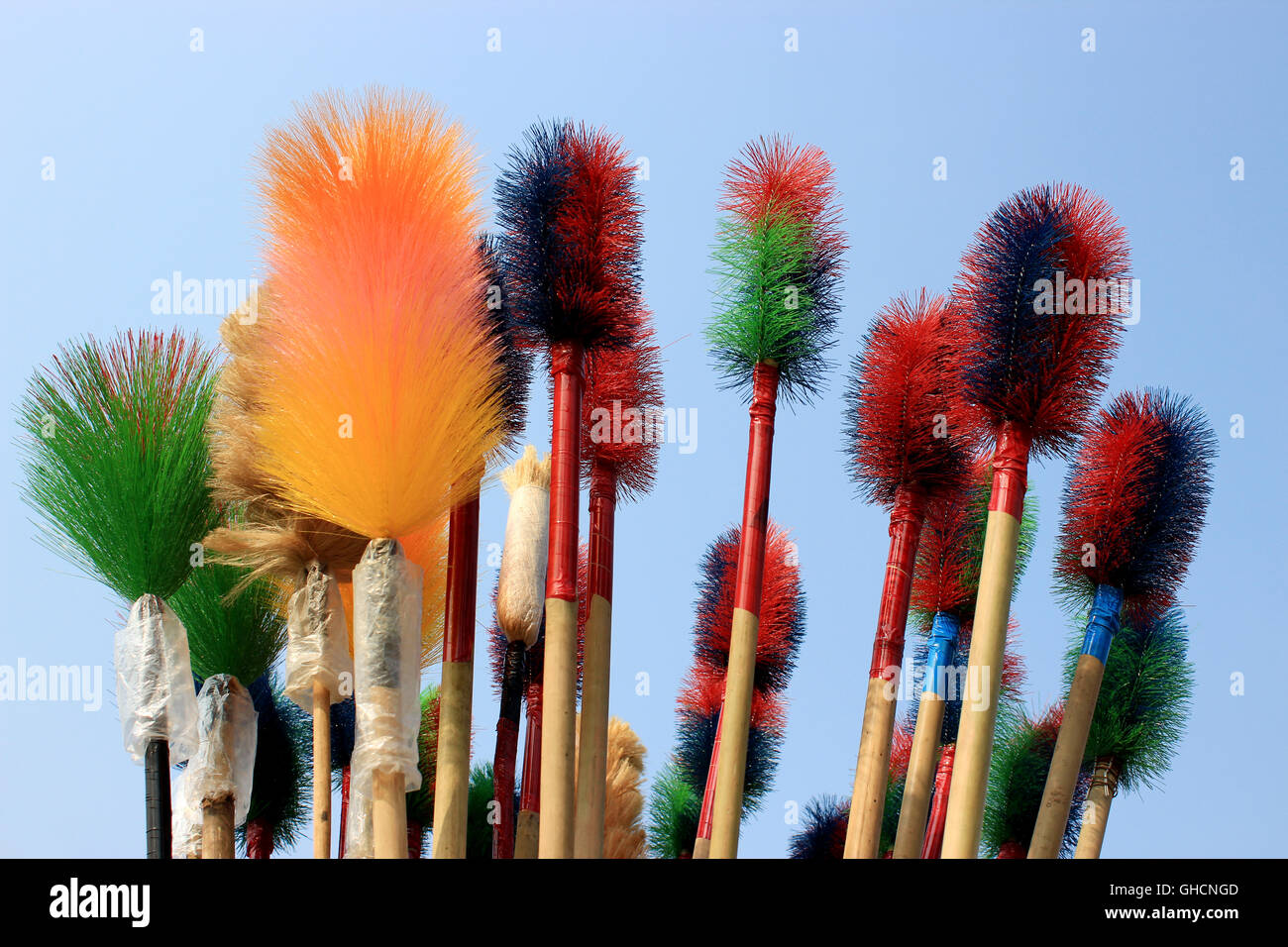 Plastic broom. These are plastic broom on sky background for cleaning the home. Stock Photo