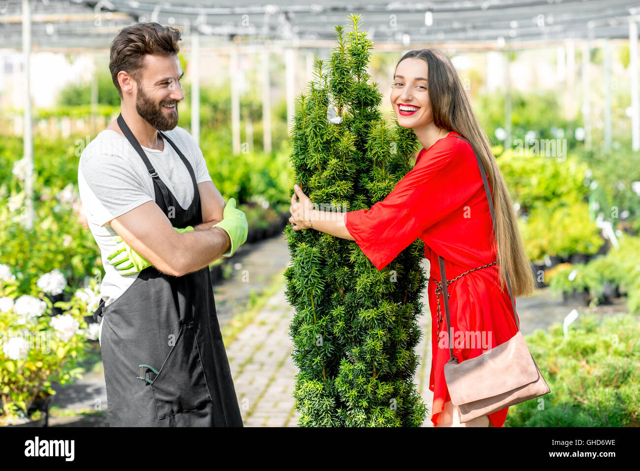 Plant seller with buyer in the shop Stock Photo