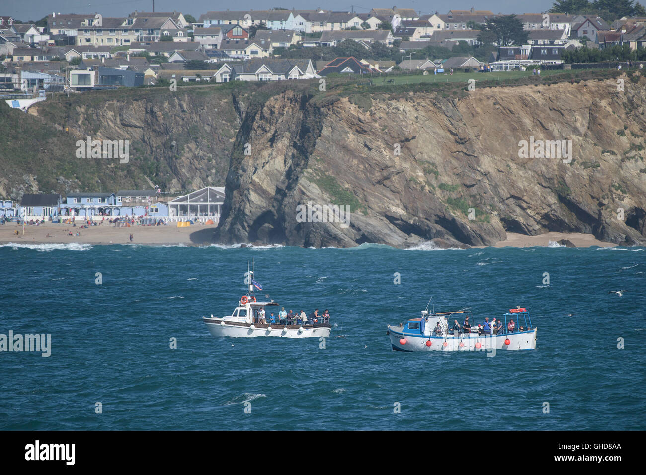 Holidaymakers mackerel fishing from boats in Newquay Bay in Cornwall Stock Photo Alamy