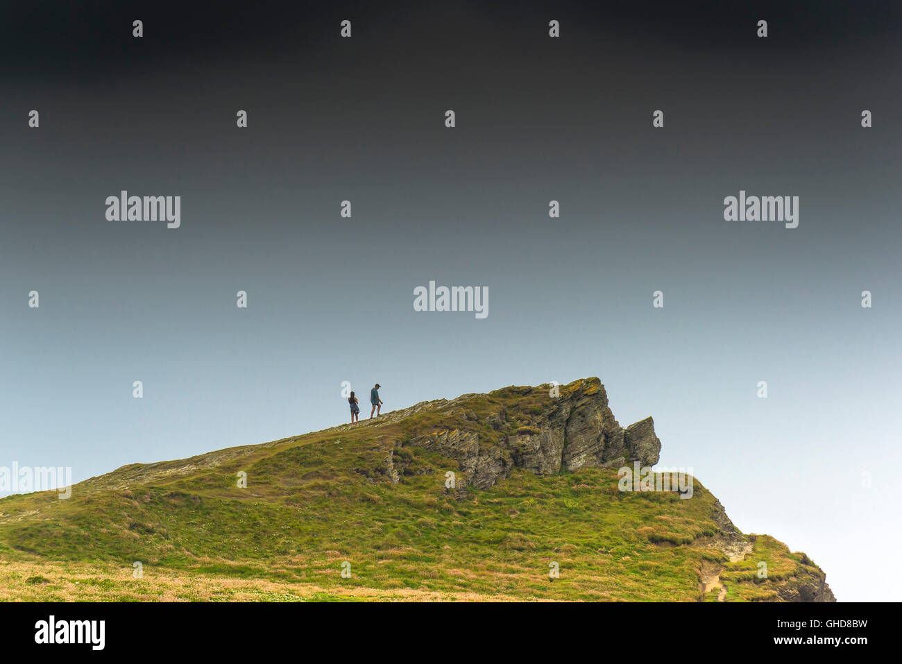 Tourists climb to the highest point on Porth Island in Newquay, Cornwall. Stock Photo