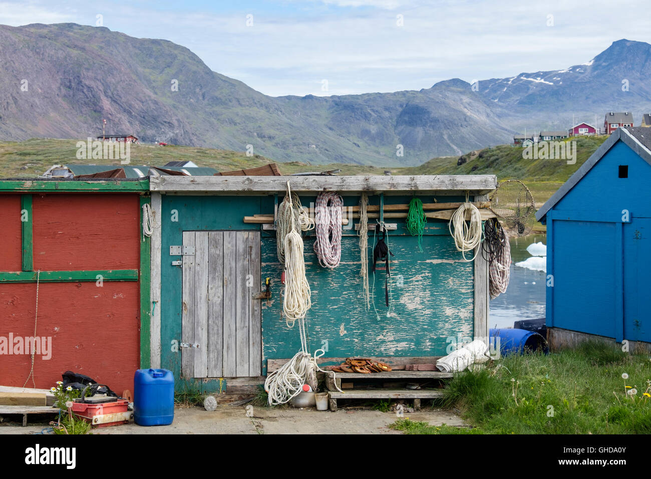 Local fisherman's hut with ropes and fishing and hunting paraphernalia hanging outside. Qajaq Harbour Narsaq Southern Greenland Stock Photo
