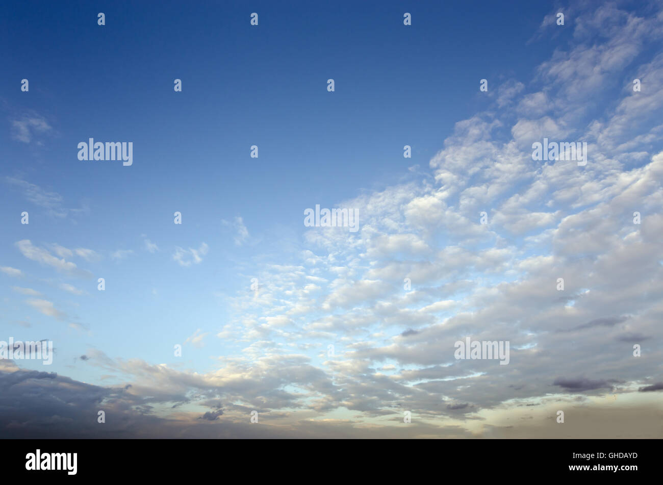 White clouds and clear blue sky during sunset time Stock Photo - Alamy
