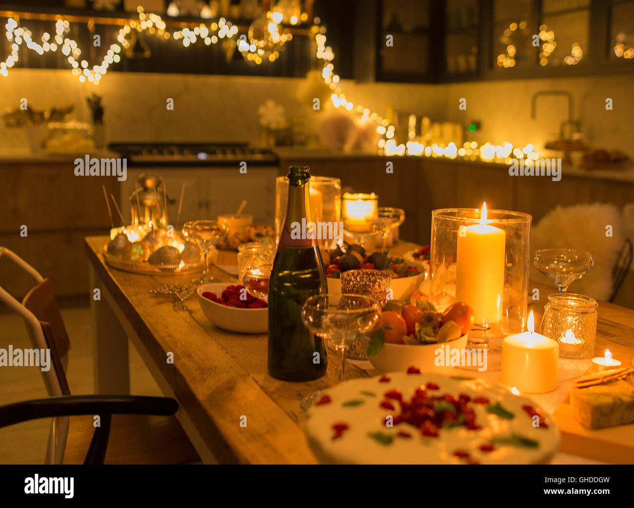 Champagne and desserts on candlelight Christmas table Stock Photo