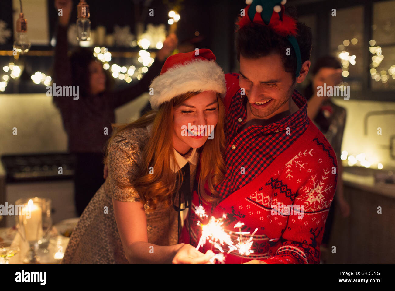 Playful couple with Christmas sparklers Stock Photo