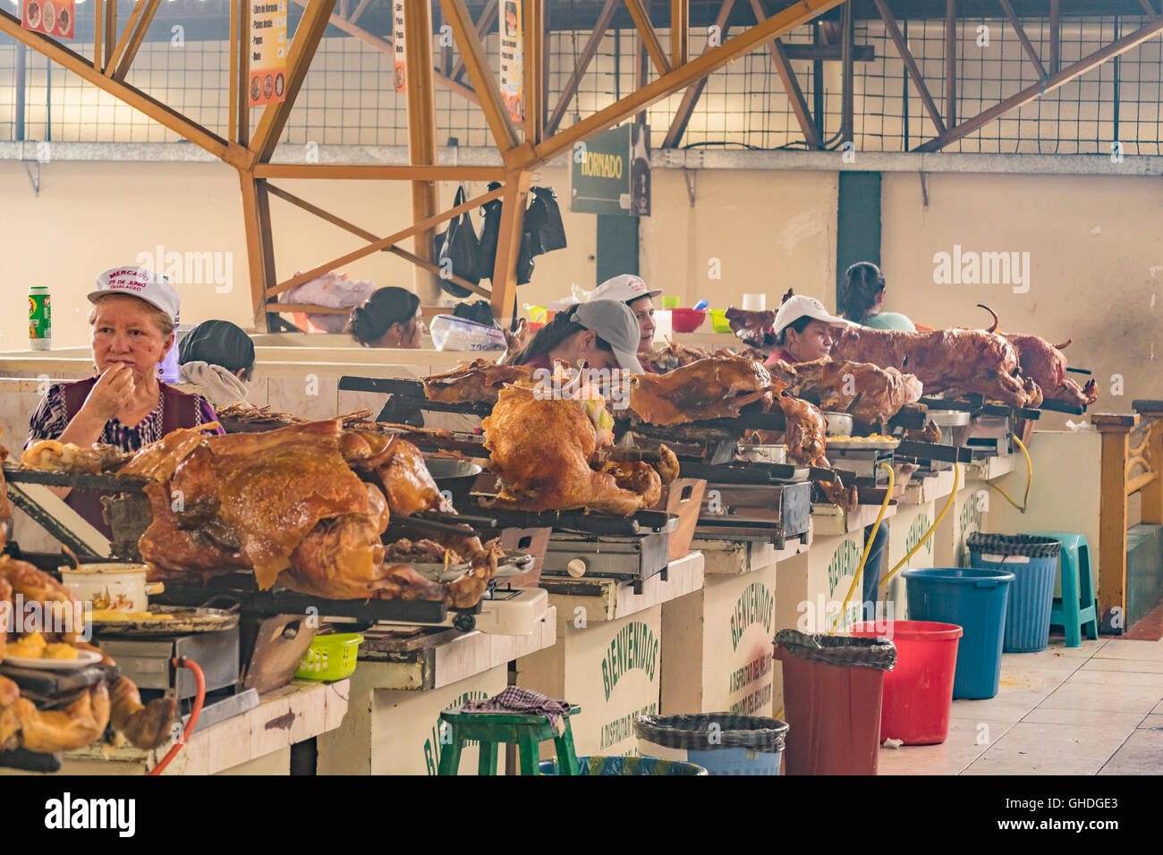 AZUAY, ECUADOR, OCTOBER - 2015 - Traditional women cooks showing his baked porks at interior popular food court in Azuay, Ecuado Stock Photo
