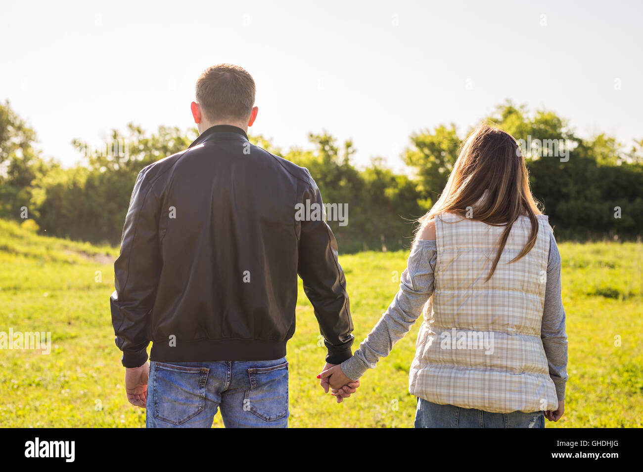 rear view of couple holding hands walking in autumn countryside Stock ...