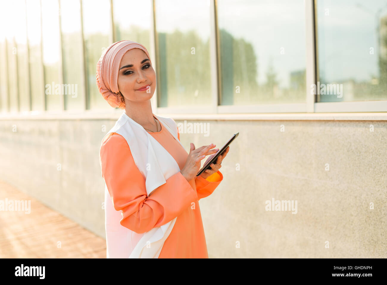 beautiful arabian girl with tablet computer. Muslim woman. Stock Photo