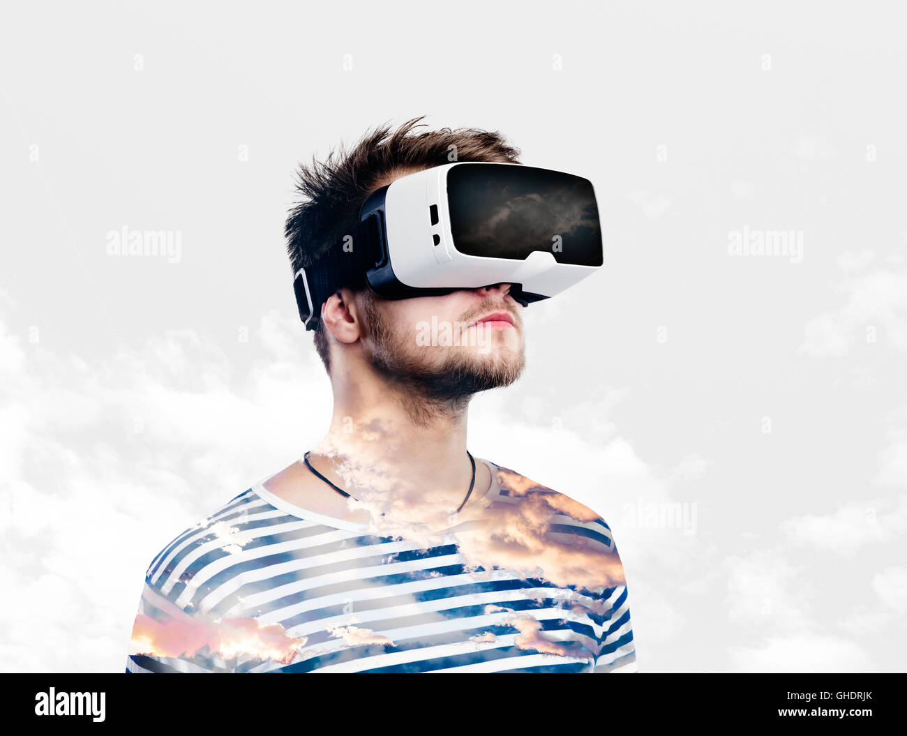 Double exposure. Man wearing virtual reality goggles. Sky and cl Stock ...