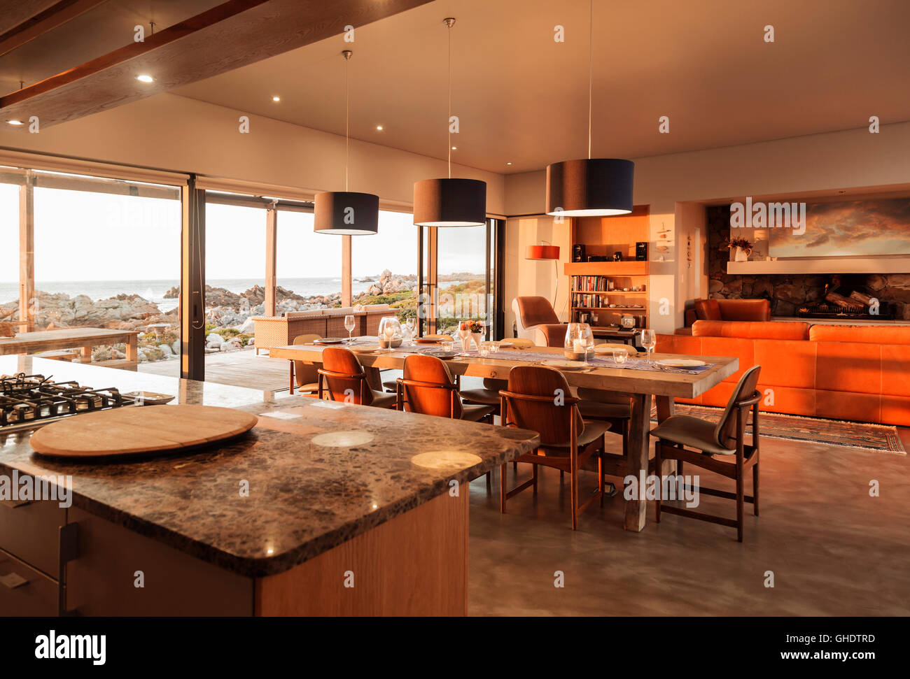 Sunny home showcase interior overlooking ocean Stock Photo - Alamy