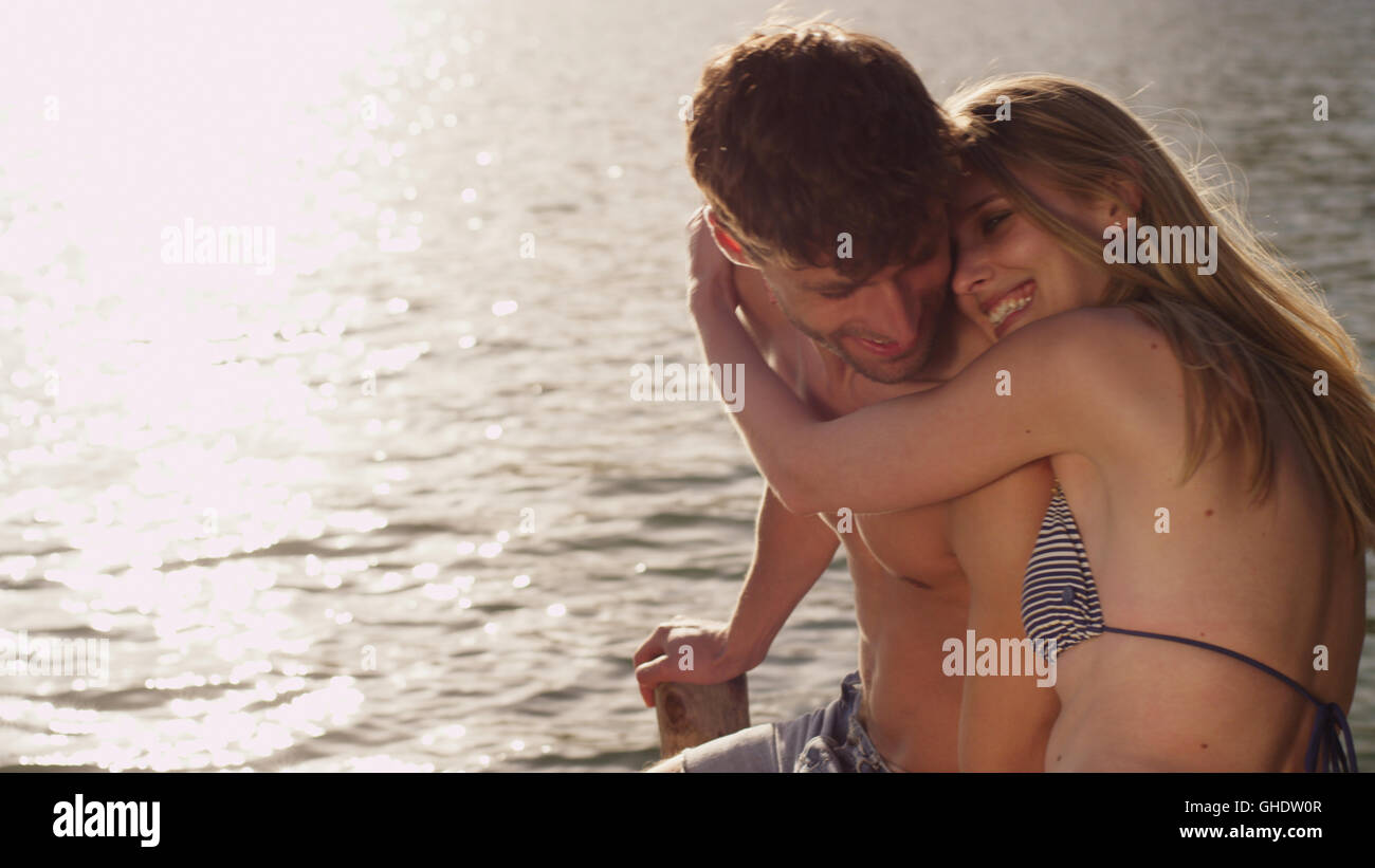 Affectionate young couple hugging at lakeside Stock Photo