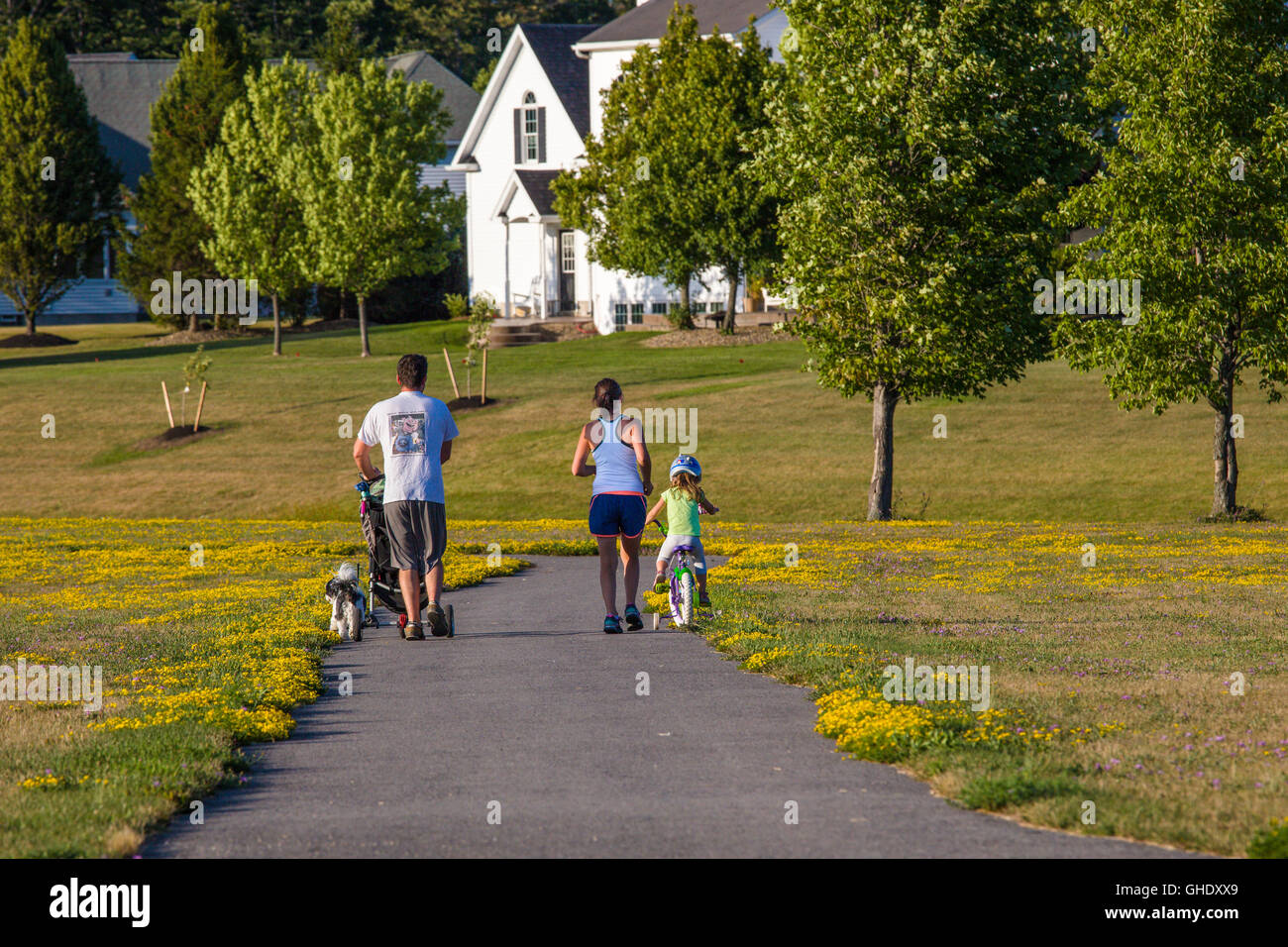 Family walking on path at Birdsong Nature area in Orchard Park New York Stock Photo